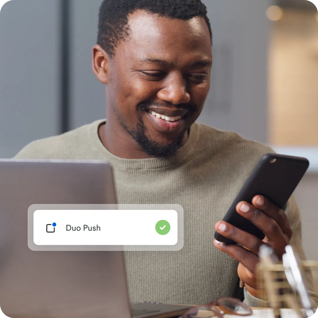 User looking at their phone to see a Duo Push notification that adds extra security to keep their account safe.